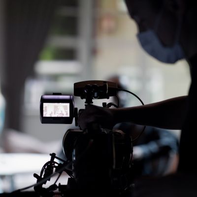 Student operating a video camera recording on the set of Senseless